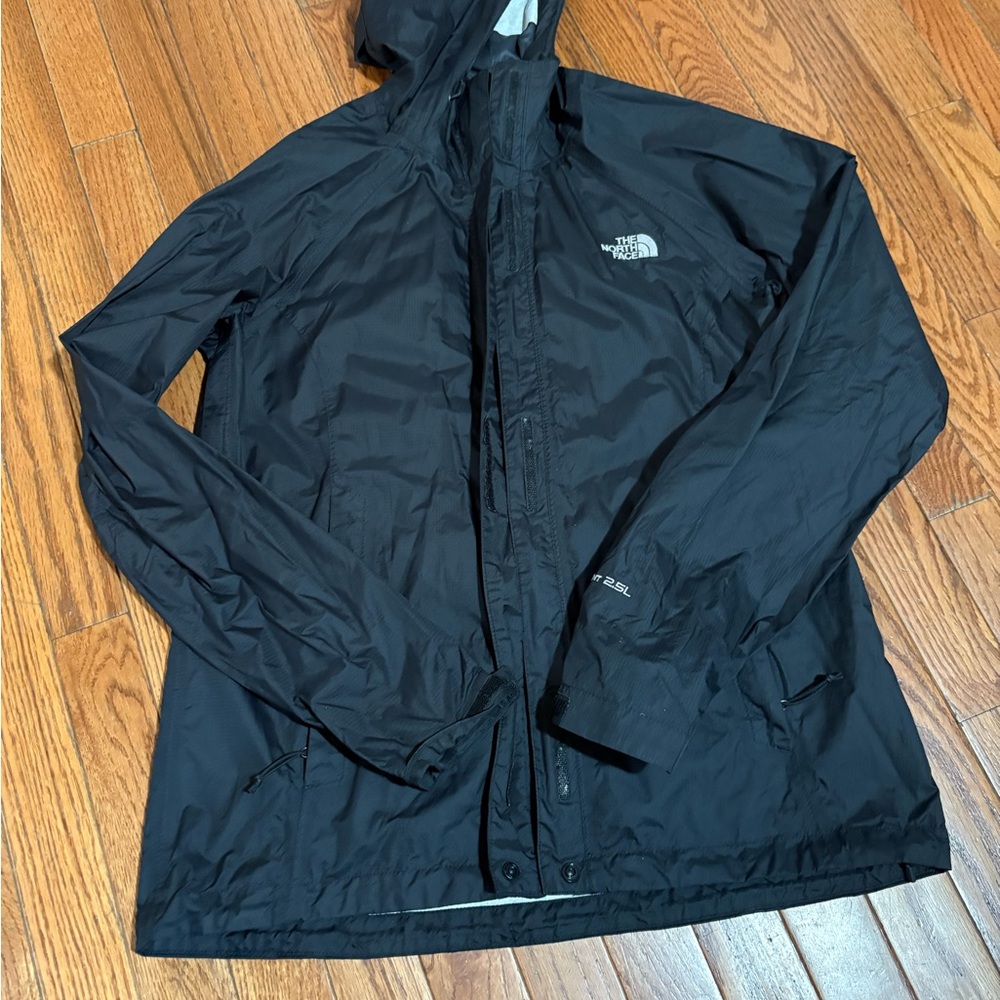 The North Face woman’s  Black Rain Jacket. liner inside starting to peel